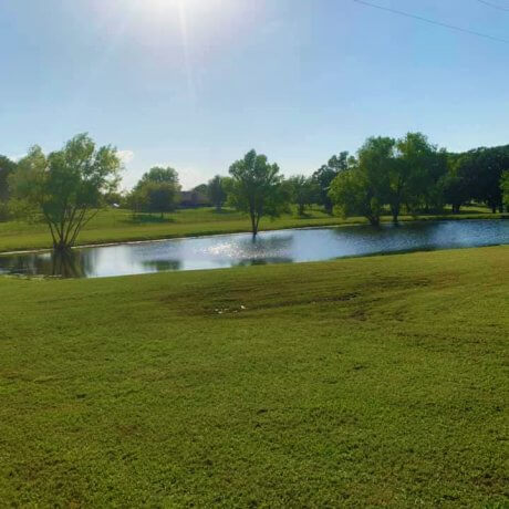 A tranquil view of a pond capturing the serene beauty of Lake Tawakoni at 429 Resort & Marina in Quinlan, TX.