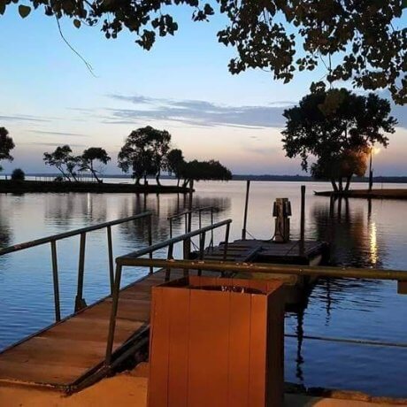 A tranquil view over the marina, featuring docked boats and the glowing lake waters—capturing the serene beauty of Lake Tawakoni at 429 Resort & Marina in Quinlan, TX.