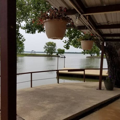 A tranquil view over the marina, featuring docked boats and the glowing lake waters—capturing the serene beauty of Lake Tawakoni at 429 Resort & Marina in Quinlan, TX.