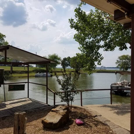 A tranquil view over the marina, featuring docked boats and the glowing lake waters—capturing the serene beauty of Lake Tawakoni at 429 Resort & Marina in Quinlan, TX.