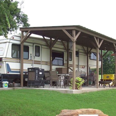 RVs parked in spacious, near a beautiful lake, showcasing the serene outdoor setting at 429 Resort & Marina in Quinlan, TX.