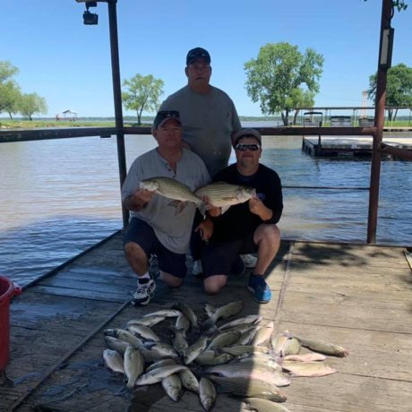 Fishing on the calm waters of Lake Tawakoni, illustrating the outdoor adventure right outside your door at 429 Resort & Marina in Quinlan, TX.